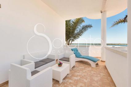 The terrace on the sea, with sofas, dining area and beach beds